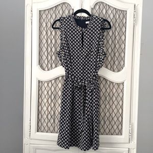 Adorable navy dress with embroidered daisy details.